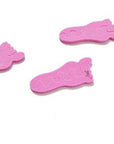 Teenie toe separators. Pink toe separators in the shape of a baby foot. White background. Place to look like foot print steps.