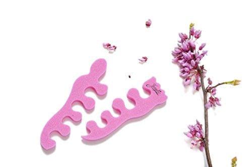 Teenie toe separators. Pink toe separators in the shape of a baby foot. White background