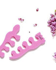 Teenie toe separators. Pink toe separators in the shape of a baby foot. White background
