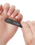 mini black nail files 100/180 grit, white background, white plastic center. women holding one nail file with French manicure.