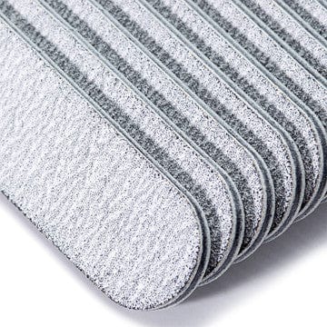 close up of mini zebra nail files stack on a white background