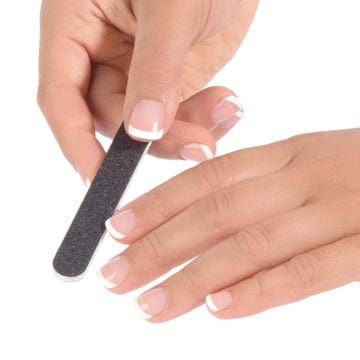 women with a French manicure holding a mini black nail file