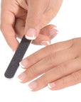 women with a French manicure holding a mini black nail file
