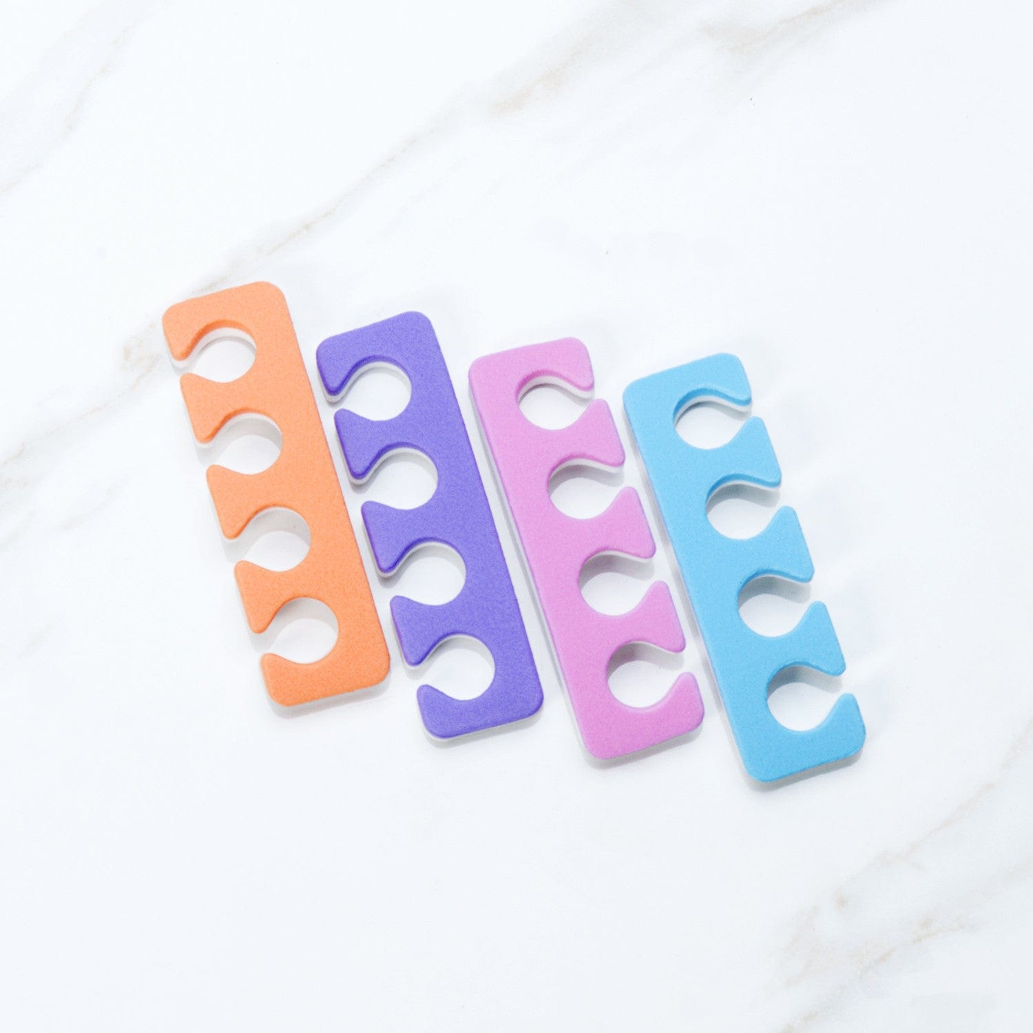 Iridesi toe separators colors are purple, blue, orange, pink on one side white on the other.
