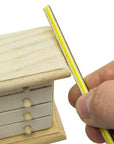 sanding sticks or twigs being used on a miniature wooden dresser