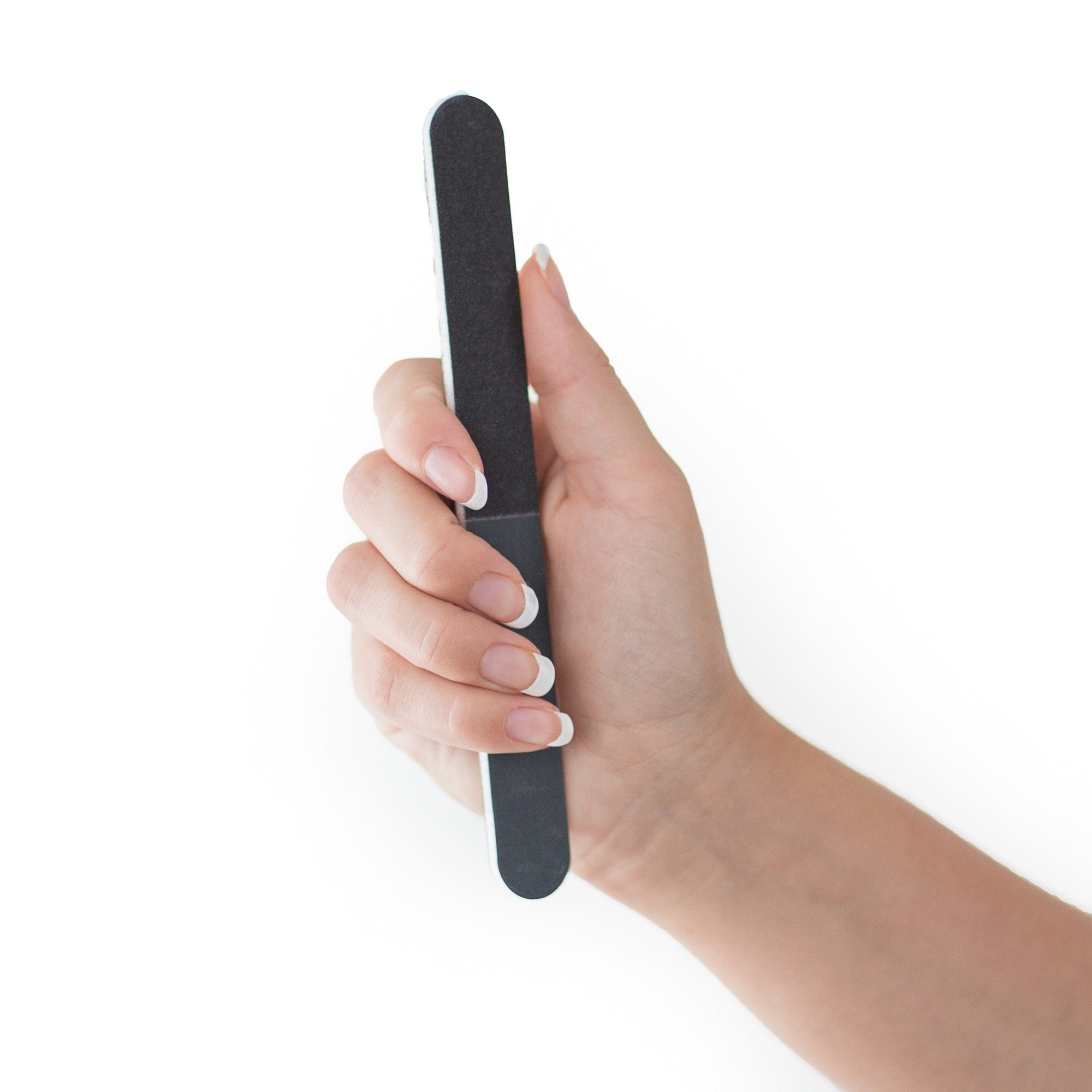 women's hand holding a black 4 way nail file, white center, round edges, white background.